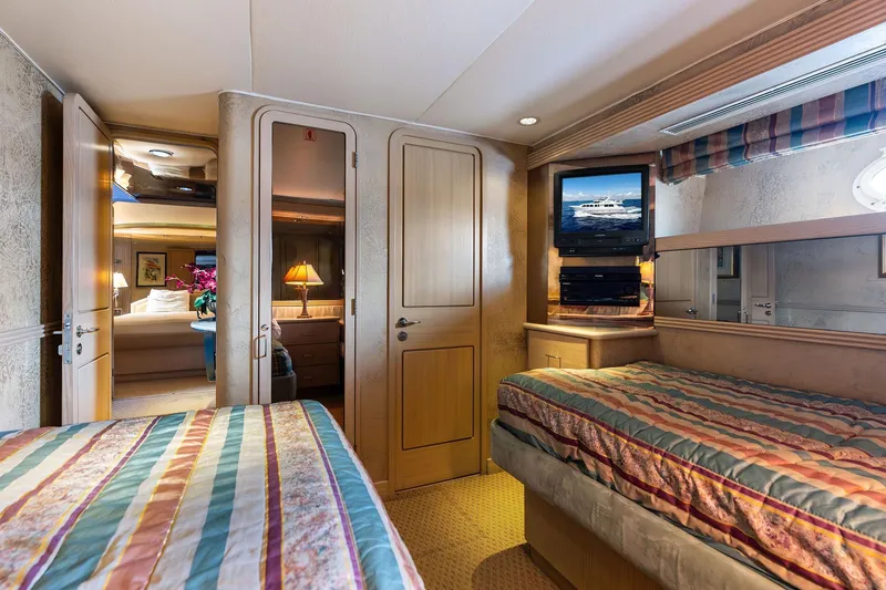 Bravo Zulu Yacht Photos Pics Luxurious 1997 Westship Raised Pilothouse Motor Yacht bedroom with twin beds and TV.