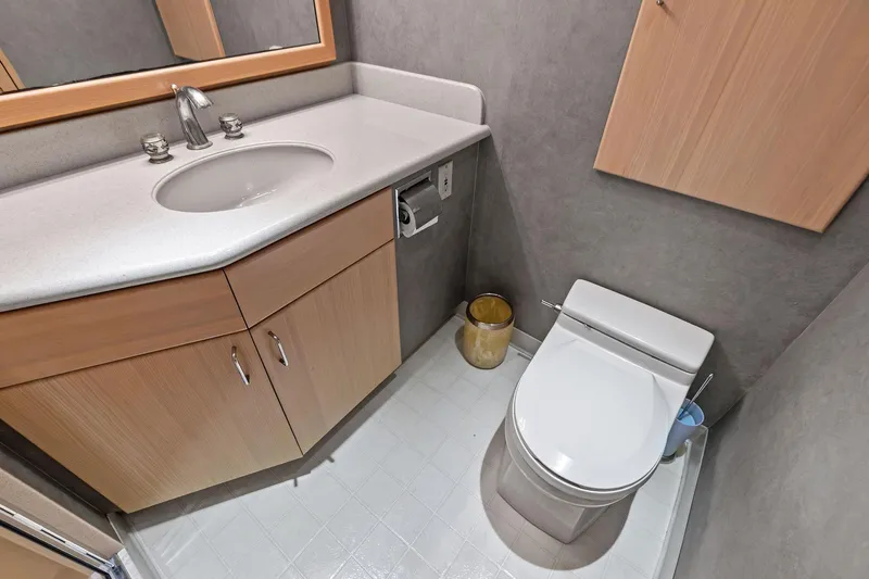 Bravo Zulu Yacht Photos Pics Bathroom interior of 1997 Westship Raised Pilothouse Motor Yacht, featuring sink and toilet.