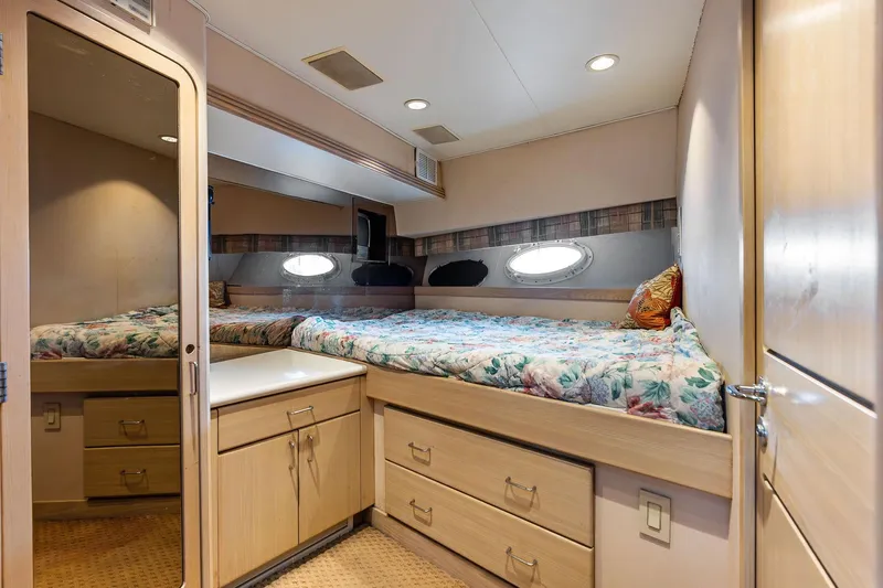 Bravo Zulu Yacht Photos Pics Cozy bedroom in 1997 Westship Raised Pilothouse Motor Yacht with floral bedding and porthole window.