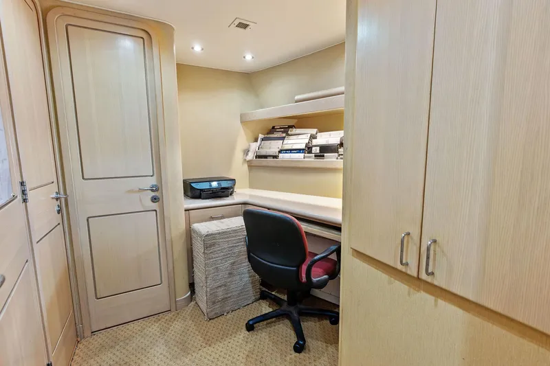 Bravo Zulu Yacht Photos Pics Office space on 1997 Westship Raised Pilothouse Motor Yacht with desk, chair, and shelves.