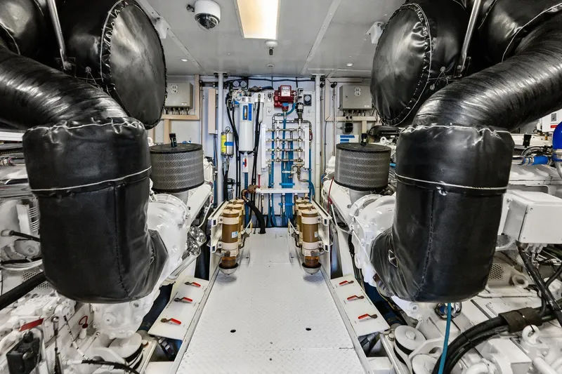 Bravo Zulu Yacht Photos Pics Engine room of a 1997 Westship Raised Pilothouse Motor Yacht, featuring dual engines.