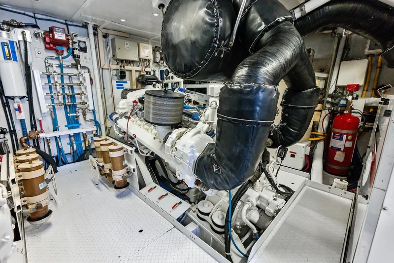 Bravo Zulu Yacht Photos Pics Engine room of a 1997 Westship Raised Pilothouse Motor Yacht, showcasing machinery and equipment.