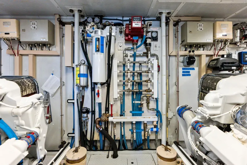 Bravo Zulu Yacht Photos Pics Engine room of 1997 Westship Raised Pilothouse Motor Yacht, showcasing complex machinery and piping.