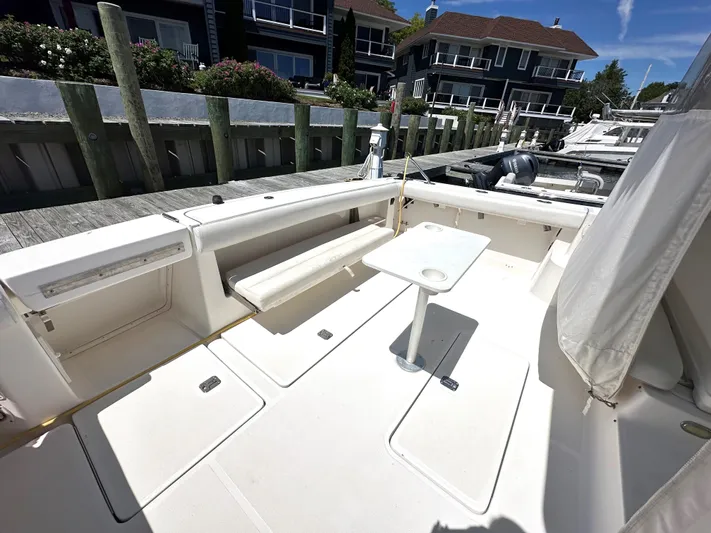  Yacht Photos Pics 2001 Tiara Yachts 3800 Open boat deck with seating and table, docked at marina.
