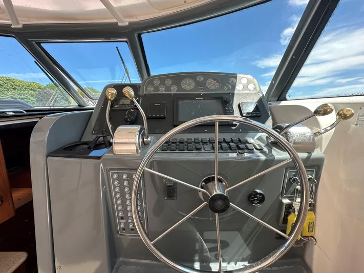  Yacht Photos Pics Helm of 2001 Tiara Yachts 3800 Open with steering wheel and control panel.