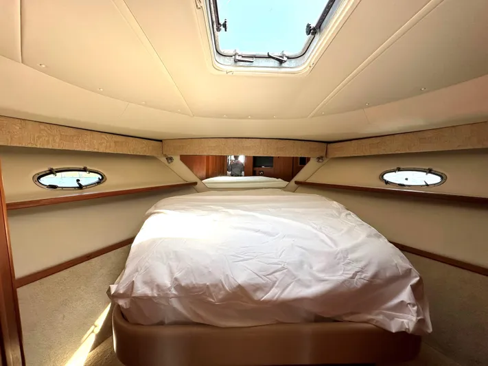  Yacht Photos Pics Luxurious bedroom interior of 2001 Tiara Yachts 3800 Open with skylight and portholes.