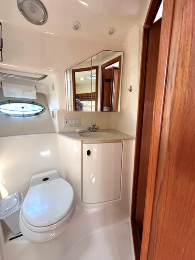  Yacht Photos Pics 2001 Tiara Yachts 3800 Open bathroom with toilet, sink, and mirror.