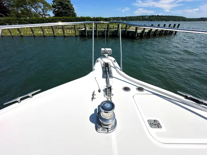  Yacht Photos Pics Bow of 2001 Tiara Yachts 3800 Open on calm water near a dock.
