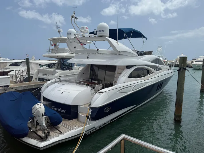 Sunshine Yacht Photos Pics 2004 Sunseeker Manhattan 64 yacht docked at marina, featuring sleek design and spacious deck.