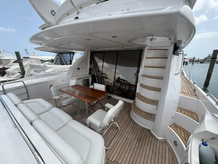 Sunshine Yacht Photos Pics 2004 Sunseeker Manhattan 64 yacht deck with seating and wooden table.