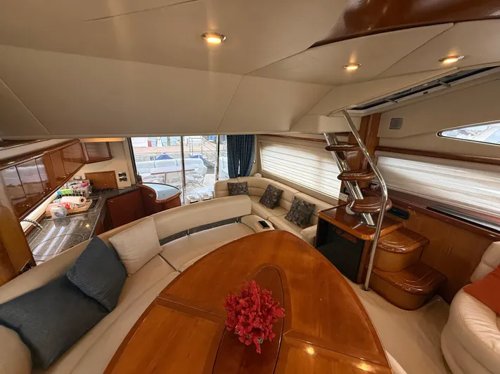 Sunshine Yacht Photos Pics Luxurious interior of 2004 Sunseeker Manhattan 64 yacht with elegant seating and wooden finishes.