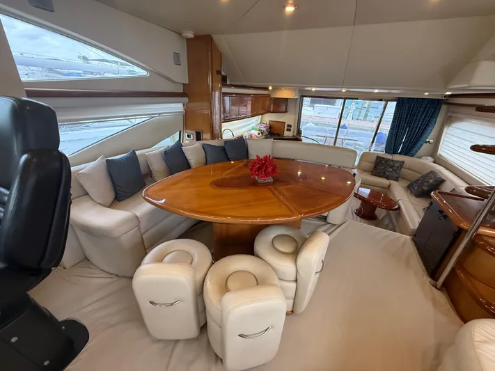 Sunshine Yacht Photos Pics Luxurious interior of 2004 Sunseeker Manhattan 64 yacht with elegant seating and dining area.