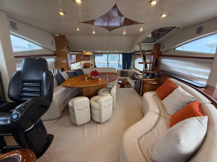 Sunshine Yacht Photos Pics Luxurious interior of 2004 Sunseeker Manhattan 64 yacht with elegant seating and dining area.