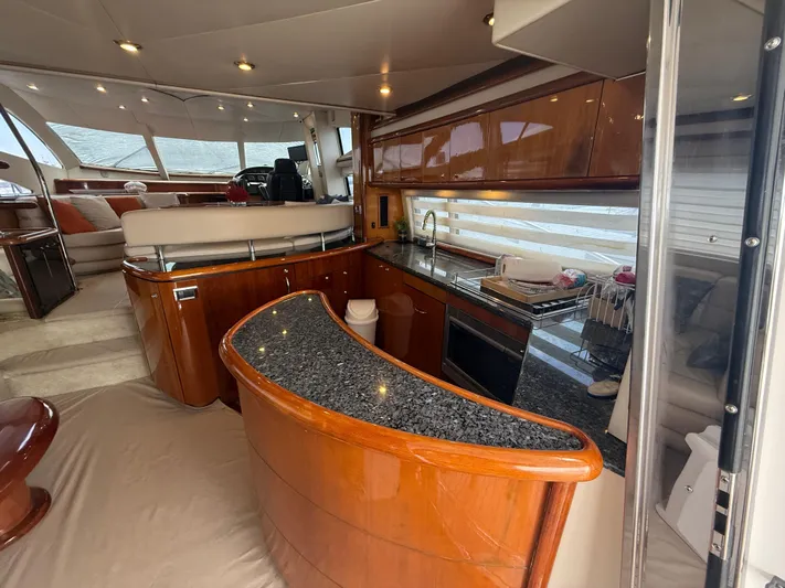 Sunshine Yacht Photos Pics Luxurious interior of 2004 Sunseeker Manhattan 64 yacht with modern kitchen and seating area.