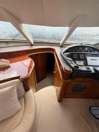 Sunshine Yacht Photos Pics Interior of 2004 Sunseeker Manhattan 64 yacht with helm and luxurious seating.