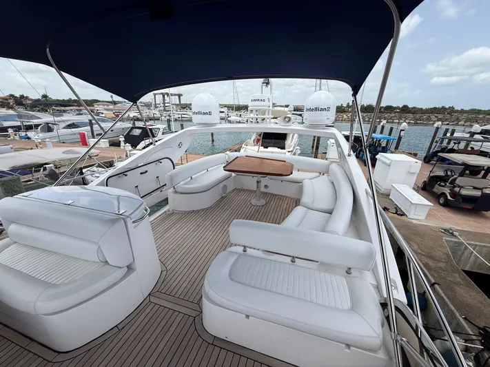 Sunshine Yacht Photos Pics 2004 Sunseeker Manhattan 64 yacht with spacious deck and seating area at marina.