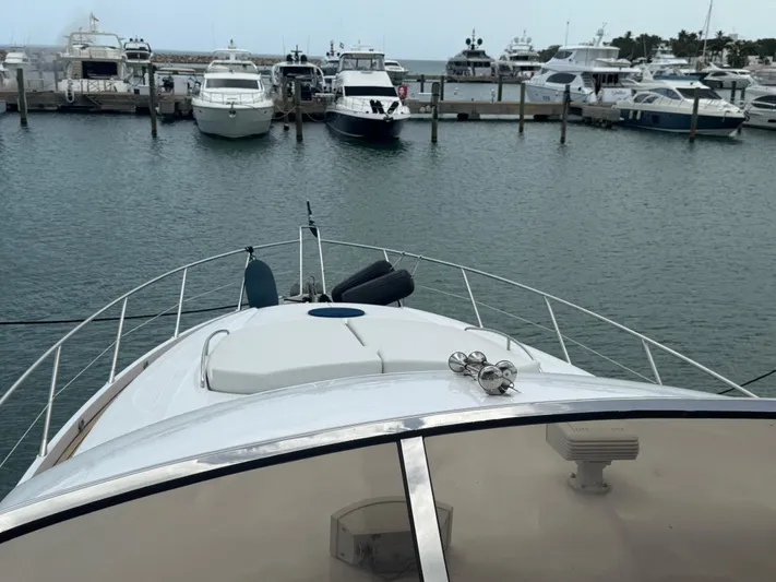 Sunshine Yacht Photos Pics Bow view of 2004 Sunseeker Manhattan 64 yacht docked in a marina.