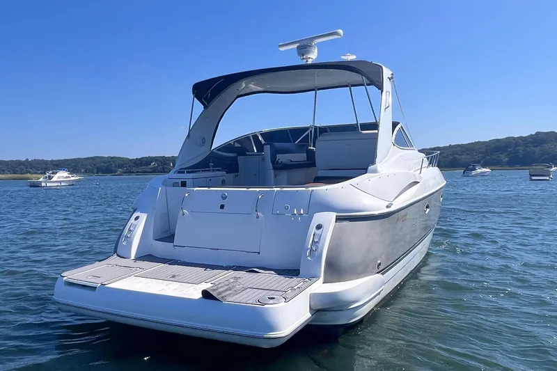  Yacht Photos Pics 2007 Cruisers Yachts 370 Express on calm water, rear view, sunny day.