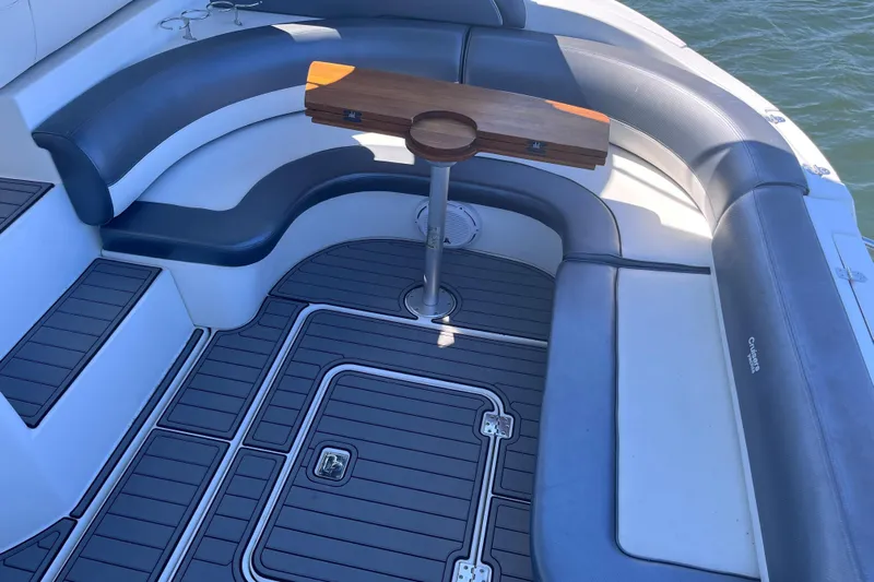  Yacht Photos Pics 2007 Cruisers Yachts 370 Express interior with curved seating and wooden table.