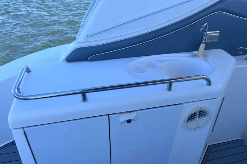  Yacht Photos Pics 2007 Cruisers Yachts 370 Express boat sink area with railing and water view.