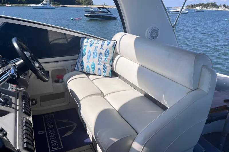  Yacht Photos Pics 2007 Cruisers Yachts 370 Express interior with white seating and nautical-themed pillow.