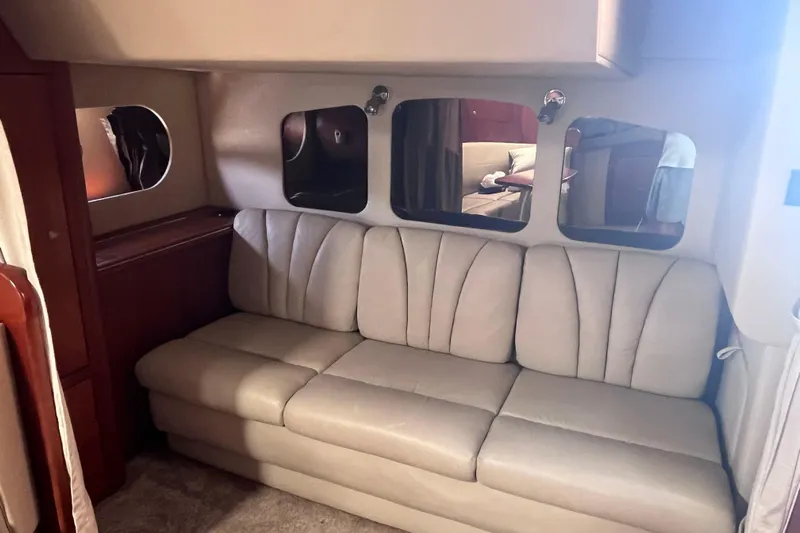  Yacht Photos Pics 2007 Cruisers Yachts 370 Express interior with beige sofa and mirrored wall accents.