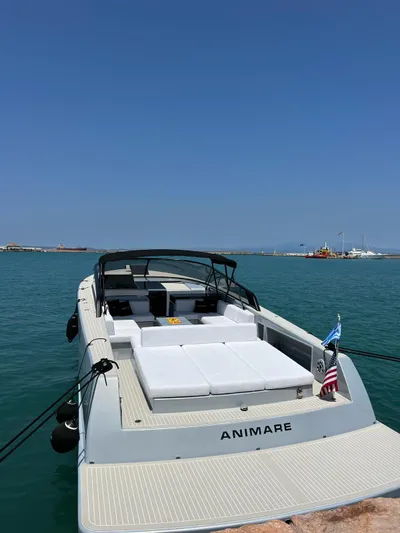  Yacht Photos Pics VanDutch 48 yacht, 2021 model, docked in a serene harbor under clear blue skies.