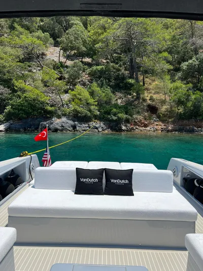  Yacht Photos Pics VanDutch 48 yacht, 2021 model, with scenic coastal view and lush greenery.