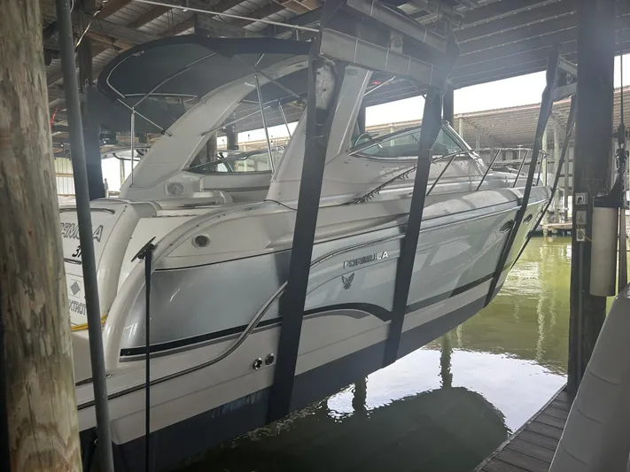  Yacht Photos Pics 2007 Formula 31 PC boat suspended in a covered dock area.