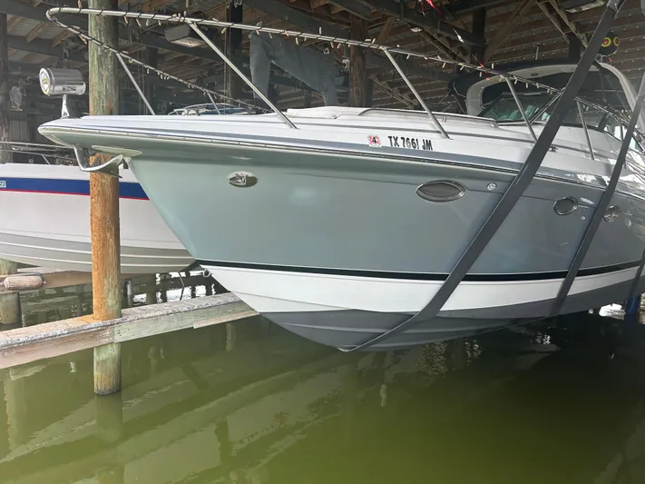  Yacht Photos Pics 2007 Formula 31 PC boat docked in a marina, partially lifted above water.