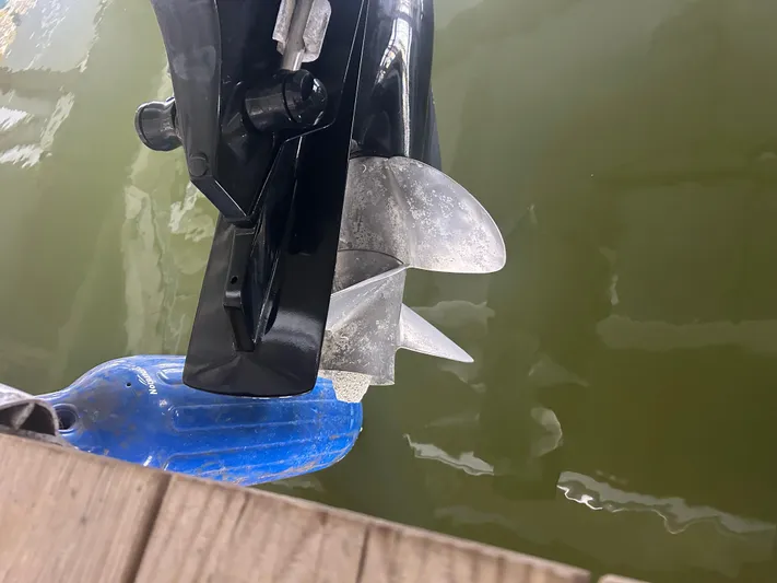  Yacht Photos Pics Propeller of a 2007 Formula 31 PC boat submerged in water near a dock.