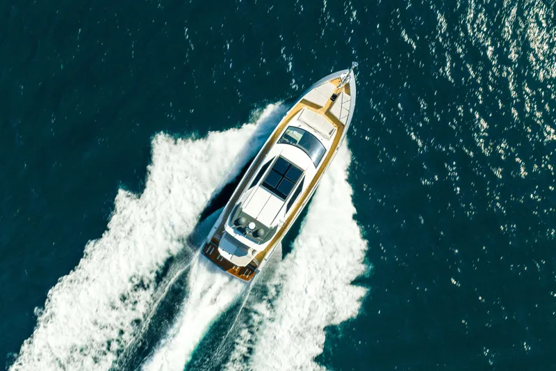 Impulse Yacht Photos Pics Aerial view of 2017 Numarine 62 Hardtop yacht cruising on open water.
