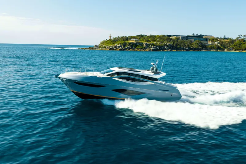 Impulse Yacht Photos Pics 2017 Numarine 62 Hardtop yacht cruising on open water near a scenic coastline.