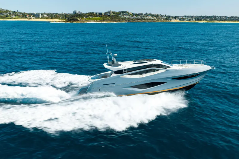 Impulse Yacht Photos Pics 2017 Numarine 62 Hardtop yacht cruising on open blue sea near coastline.