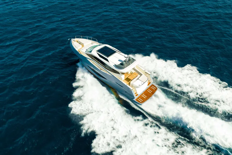 Impulse Yacht Photos Pics 2017 Numarine 62 Hardtop yacht cruising on open sea, aerial view.