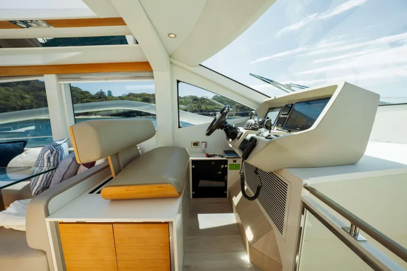 Impulse Yacht Photos Pics Interior view of 2017 Numarine 62 Hardtop yacht cockpit with modern controls and seating.