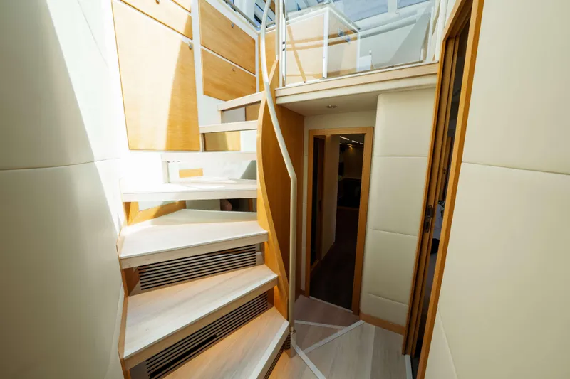 Impulse Yacht Photos Pics Interior of 2017 Numarine 62 Hardtop yacht with modern staircase and wood paneling.