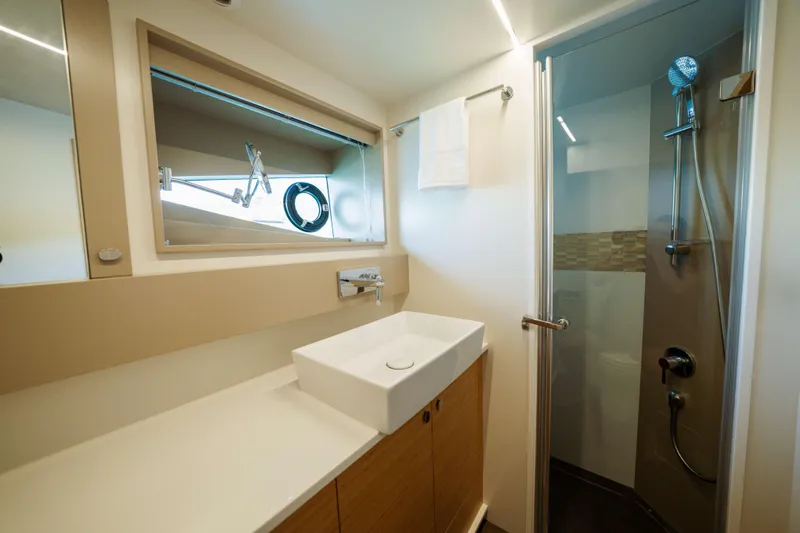 Impulse Yacht Photos Pics Luxurious bathroom in 2017 Numarine 62 Hardtop yacht, featuring modern sink and shower.