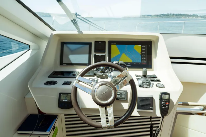 Impulse Yacht Photos Pics Cockpit of 2017 Numarine 62 Hardtop yacht with navigation screens and controls.