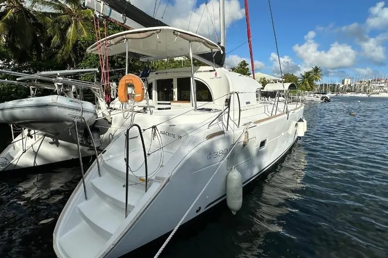 Nacrite Yacht Photos Pics 2018 Lagoon 380 catamaran docked in a tropical marina under blue skies.