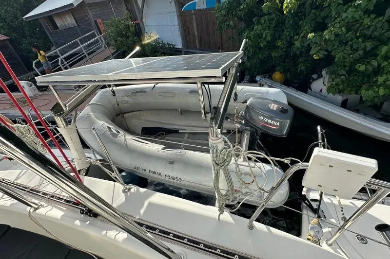 Nacrite Yacht Photos Pics Lagoon 380 catamaran with solar panel and Yamaha motor, docked near wooden buildings, 2018 model.