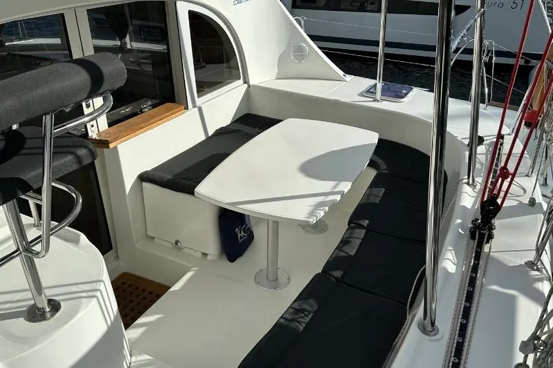 Nacrite Yacht Photos Pics 2018 Lagoon 380 catamaran cockpit with seating and table, featuring sleek design and modern amenities.