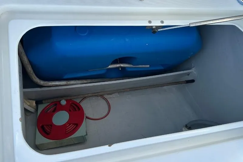 Nacrite Yacht Photos Pics Storage compartment of a 2018 Lagoon 380 catamaran with blue tank and red reel.