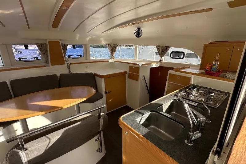 Nacrite Yacht Photos Pics Interior of 2018 Lagoon 380 catamaran with kitchen, dining area, and scenic windows.
