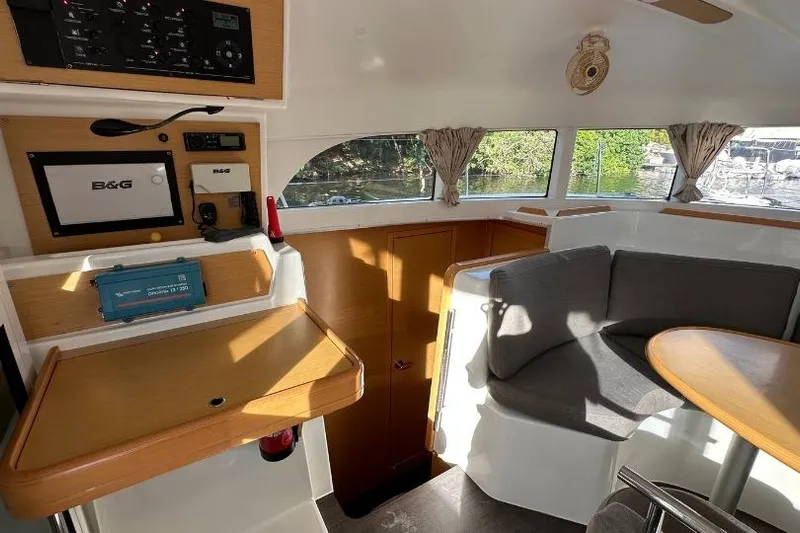 Nacrite Yacht Photos Pics Interior of 2018 Lagoon 380 catamaran with navigation equipment and cozy seating area.