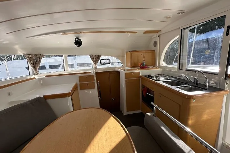 Nacrite Yacht Photos Pics Interior of 2018 Lagoon 380 catamaran with kitchen and seating area.