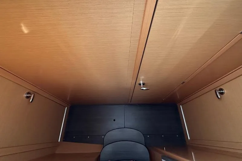 Nacrite Yacht Photos Pics Interior cabin of a 2018 Lagoon 380 catamaran, featuring wooden cabinetry and modern design.