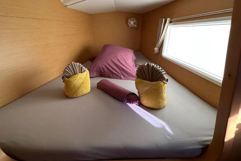 Nacrite Yacht Photos Pics Cozy cabin interior of 2018 Lagoon 380 catamaran with neatly arranged bed and towels.