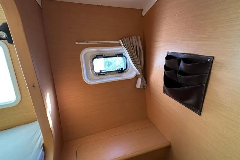 Nacrite Yacht Photos Pics Interior cabin of 2018 Lagoon 380 catamaran with window and storage pockets.