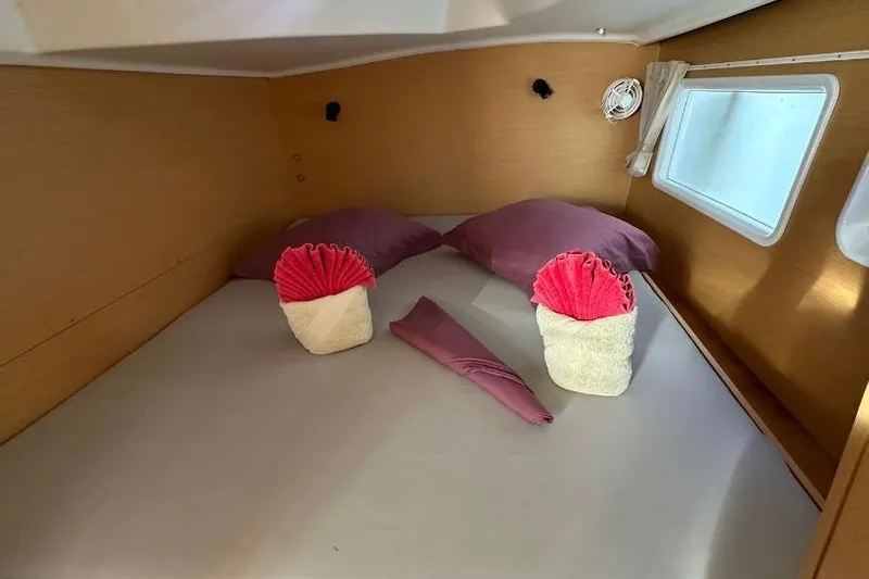 Nacrite Yacht Photos Pics Cozy cabin interior of 2018 Lagoon 380 catamaran with neatly arranged towels and pillows.